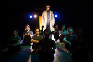 AXtor as Korotkove with cast seated about him