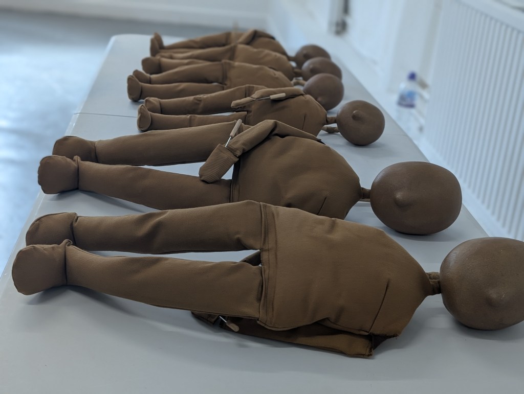 a table with a series of puppets lying on their sies waiting to be used in the workshop